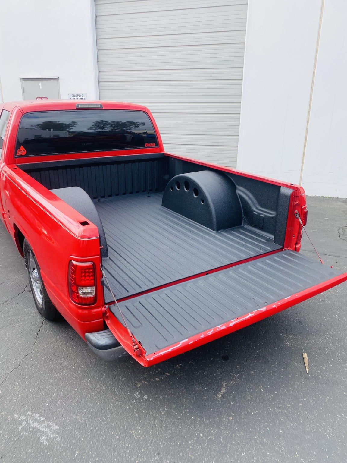 Red pickup with coated bed